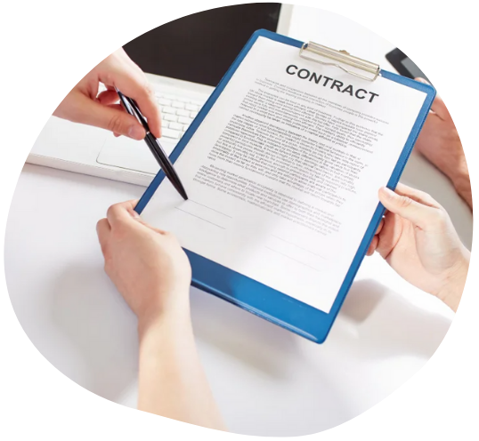 Person holding a clipboard with a contract, another person pointing at it with a pen.